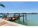 Waterfront dock with boat lift, providing direct access to the open water at 16353 Redington Dr, Redington Beach, FL 33708