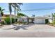 Charming single-story home featuring a paved driveway, well-maintained landscaping, and an attached garage at 16353 Redington Dr, Redington Beach, FL 33708