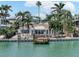 Waterfront home, complete with a private dock, blending indoor-outdoor living in a tropical paradise at 16353 Redington Dr, Redington Beach, FL 33708