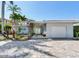 Charming single-story home with a lush front yard and driveway at 16353 Redington Dr, Redington Beach, FL 33708