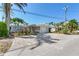 Charming single-story home featuring a paved driveway, well-maintained landscaping, and an attached garage at 16353 Redington Dr, Redington Beach, FL 33708