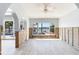 Spacious room featuring tile flooring, arched entryways, high ceilings, and large windows to outdoor space at 16353 Redington Dr, Redington Beach, FL 33708