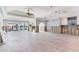 Spacious room featuring tile flooring, arched entryways, high ceilings, and sliding doors to outdoor space at 16353 Redington Dr, Redington Beach, FL 33708