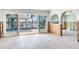 Spacious room featuring tile flooring, arched entryways, high ceilings, and sliding doors to a pool at 16353 Redington Dr, Redington Beach, FL 33708