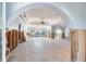 Spacious room featuring tile flooring, arched entryways, high ceilings, and sliding doors to outdoor space at 16353 Redington Dr, Redington Beach, FL 33708