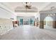 Spacious room featuring tile flooring, arched entryways, high ceilings, and sliding doors to outdoor space at 16353 Redington Dr, Redington Beach, FL 33708