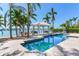 Resort-style pool with a covered gazebo, waterfront access, and lush tropical landscaping at 16353 Redington Dr, Redington Beach, FL 33708