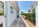 Side yard walkway with updated white exterior and access to the backyard and waterfront at 16353 Redington Dr, Redington Beach, FL 33708