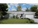 Charming single-story home featuring a well-manicured lawn and attached two-car garage at 18479 Poston Ave, Port Charlotte, FL 33948