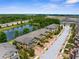 Aerial view of townhomes showcasing the community's prime location, water view, and lush surroundings at 1969 Milkweed Trce, Lutz, FL 33558