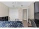 Bright bedroom with white closet, window, carpet, and modern ceiling fan at 1969 Milkweed Trce, Lutz, FL 33558