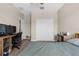 Bright bedroom featuring carpet, ceiling fan, and a closet with double doors at 1969 Milkweed Trce, Lutz, FL 33558