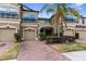 Charming townhome featuring a brick drive, two-car garage, and well-maintained landscaping at 1969 Milkweed Trce, Lutz, FL 33558