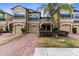 Charming townhome featuring a brick drive, two-car garage, and well-maintained landscaping at 1969 Milkweed Trce, Lutz, FL 33558