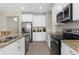 Modern kitchen featuring granite countertops and stainless steel appliances, a stylish and functional design at 1969 Milkweed Trce, Lutz, FL 33558