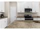 Granite countertops, stainless steel appliances, and white cabinets create an inviting culinary space at 1969 Milkweed Trce, Lutz, FL 33558