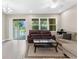 Cozy living room with sliding doors, tile floors, and comfortable seating, perfect for entertaining at 1969 Milkweed Trce, Lutz, FL 33558