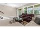 Inviting living room with tile floors, a neutral color palette, and large windows for natural light at 1969 Milkweed Trce, Lutz, FL 33558