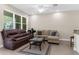 Bright living room featuring tile floors, neutral tones, and ample seating for relaxation at 1969 Milkweed Trce, Lutz, FL 33558