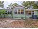This backyard features an AC unit and several windows at 1984 Trotter Rd, Largo, FL 33774