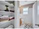 This bathroom features a toilet, wooden vanity, a shower, and a built-in cabinet at 1984 Trotter Rd, Largo, FL 33774