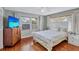 Bedroom with a white bedspread, wood floors, and two windows for plenty of natural light at 1984 Trotter Rd, Largo, FL 33774
