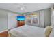Bedroom featuring hardwood floors, a white bed, two windows, and a closet at 1984 Trotter Rd, Largo, FL 33774