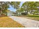 View of the front exterior showing the garage and long driveway to the home at 1984 Trotter Rd, Largo, FL 33774