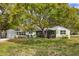 Charming single-story home with a well-manicured lawn and mature shade tree at 1984 Trotter Rd, Largo, FL 33774