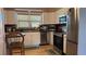 Well-lit kitchen features stainless steel appliances and wood-style flooring at 1984 Trotter Rd, Largo, FL 33774
