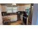Bright kitchen with stainless steel appliances, laminate countertops, and a dining area at 1984 Trotter Rd, Largo, FL 33774