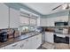 Bright kitchen with mosaic backsplash, stainless steel appliances, and window at 1984 Trotter Rd, Largo, FL 33774