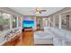 Cozy living room featuring hardwood floors, a comfortable white sectional, and windows at 1984 Trotter Rd, Largo, FL 33774