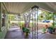 Inviting porch with a swing, foliage, and views of the surrounding area at 1984 Trotter Rd, Largo, FL 33774
