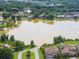 Aerial view of neighborhood houses surrounding a lake with private boat docks at 21878 Amelia Rose Way, Land O Lakes, FL 34637