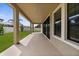 View of the back patio showing large pillars, tile, and a view of the spacious and fenced backyard at 21878 Amelia Rose Way, Land O Lakes, FL 34637