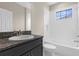 Clean bathroom features a dark vanity and a bathtub with white tile surround at 21878 Amelia Rose Way, Land O Lakes, FL 34637