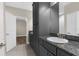 Well-lit bathroom with a modern vanity, granite countertops and convenient storage options at 21878 Amelia Rose Way, Land O Lakes, FL 34637