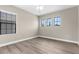 Bright bedroom with hardwood floors, lots of natural light, and a ceiling fan at 21878 Amelia Rose Way, Land O Lakes, FL 34637