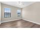Spacious bedroom with wood laminate flooring and two large windows at 21878 Amelia Rose Way, Land O Lakes, FL 34637
