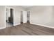Bedroom with wood floors featuring 3 open doorways leading to additional rooms and areas at 21878 Amelia Rose Way, Land O Lakes, FL 34637