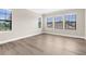Bright bedroom features hardwood floors, windows, and neutral paint, creating a relaxing retreat at 21878 Amelia Rose Way, Land O Lakes, FL 34637
