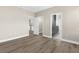 Bedroom with wood floors featuring 3 open doorways leading to additional rooms and areas at 21878 Amelia Rose Way, Land O Lakes, FL 34637