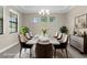 Virtually staged dining room features an elegant dining table, chairs, and modern decor at 21878 Amelia Rose Way, Land O Lakes, FL 34637