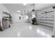 Spacious three car garage features a clean white epoxy floor and overhead storage at 21878 Amelia Rose Way, Land O Lakes, FL 34637