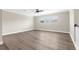 Bright and spacious living room boasts hardwood floors and large windows, offering ample natural light at 21878 Amelia Rose Way, Land O Lakes, FL 34637