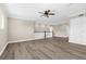 Spacious living room boasts recessed lighting, a ceiling fan, and hardwood floors for a sleek and modern feel at 21878 Amelia Rose Way, Land O Lakes, FL 34637
