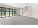 A bright living room featuring sliding glass doors to the backyard, and a staircase at 21878 Amelia Rose Way, Land O Lakes, FL 34637