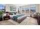 Beautiful main bedroom is virtually staged with hardwood floors, comfortable seating and calming colors at 21878 Amelia Rose Way, Land O Lakes, FL 34637