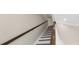 Staircase featuring white risers, wood treads, and a dark wood handrail at 21878 Amelia Rose Way, Land O Lakes, FL 34637